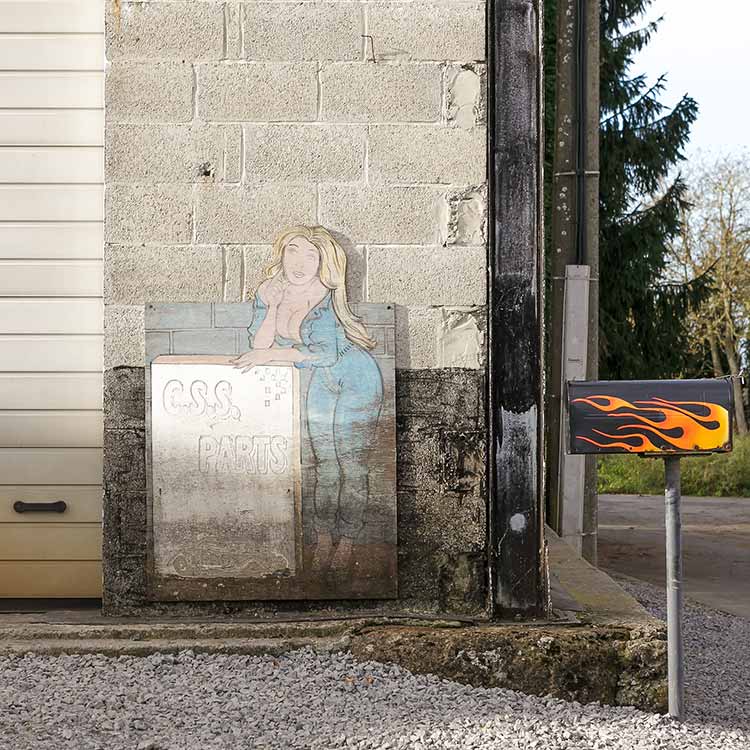 A billboard with a pin-up for a motorcycle shop