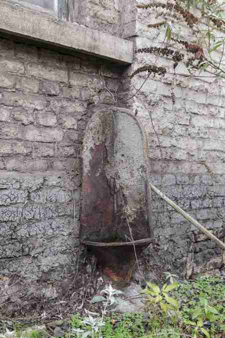 An outdoor urinal at an abandoned steel mill