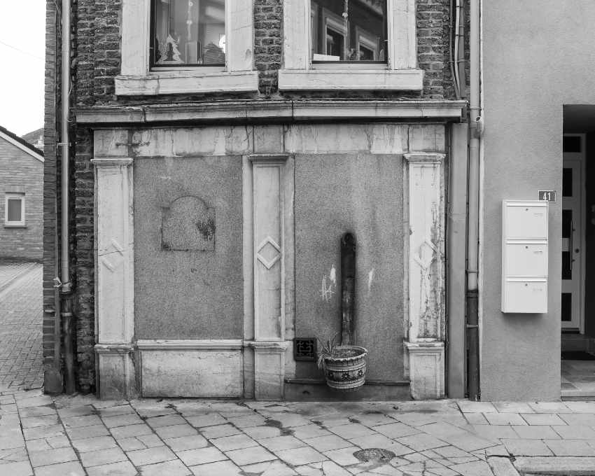 House with a Christmas tree in front of the window on the first floor