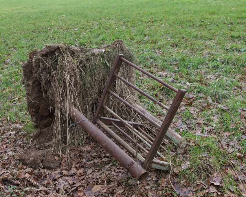 A fallen swing gate without a walking path