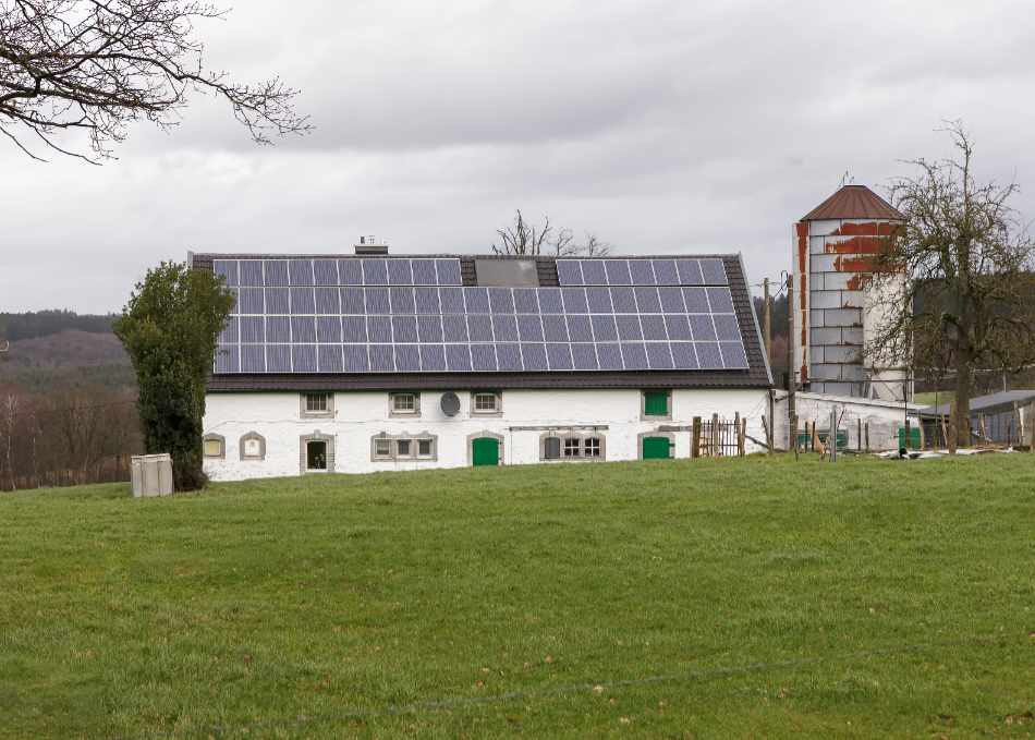 A farm with a roof covered with solar panels