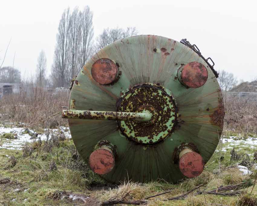 A collapsed storage tank at an abandoned tannery