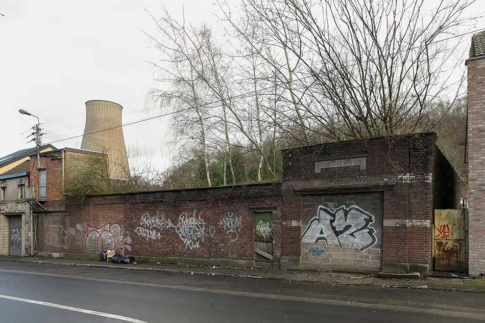 Graffiti on a wall and the bricked-up entrance of a school
