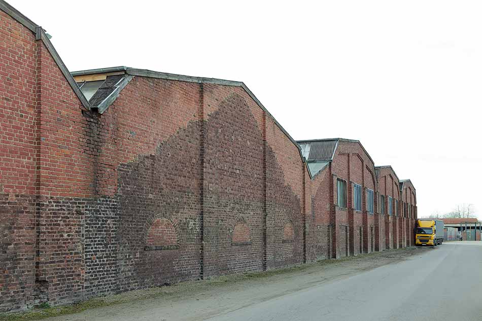 A facade of industrial halls with a variety of bricks
