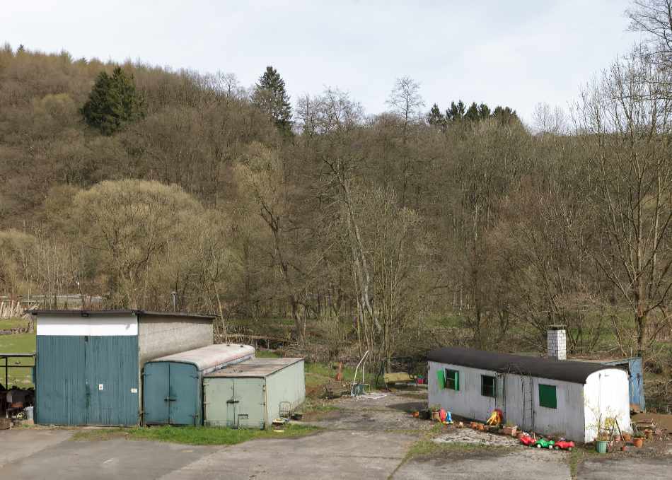 A few sheds and children's toys in a rural setting