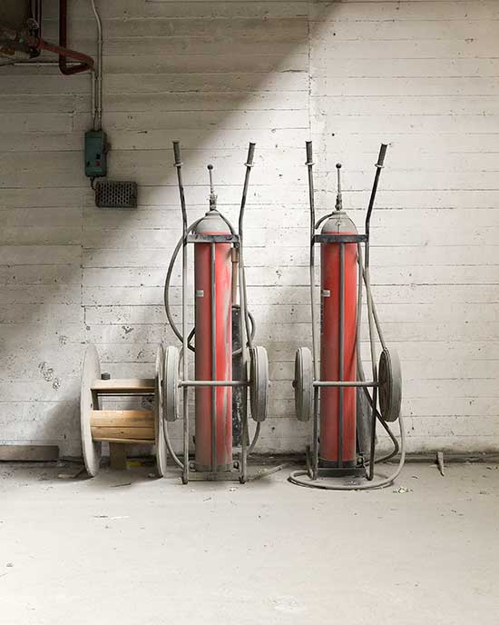 Several fire extinguishers in an abandoned cement factory
