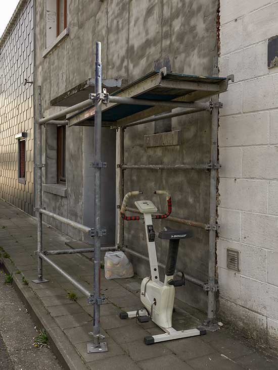 A house under construction with an exercise bike