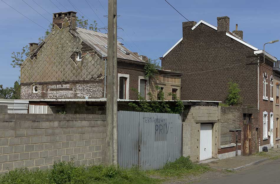 A dilapidated, vacant house with the sign "Private"